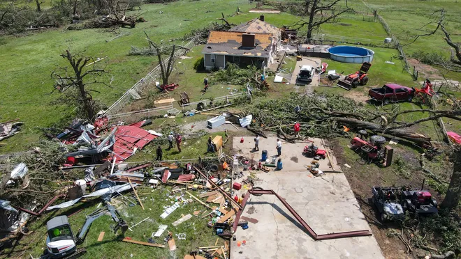 Aerial view of tornado damage in Claremore showing destroyed structures and debris fields