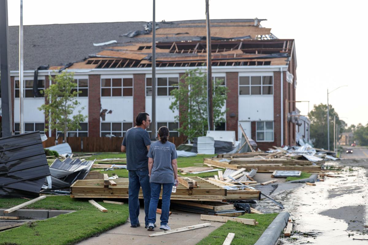 Survivors surveying damage to their home after the Claremore tornado